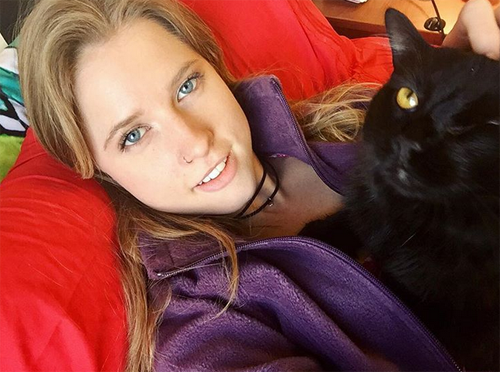 black one eyed emotional support cat